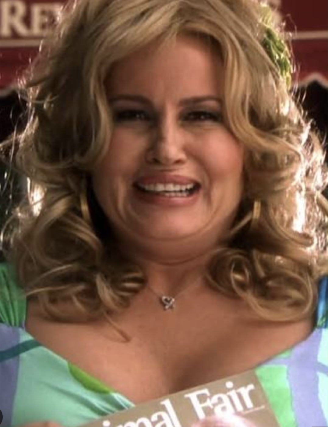 A smiling woman with big blonde curls.