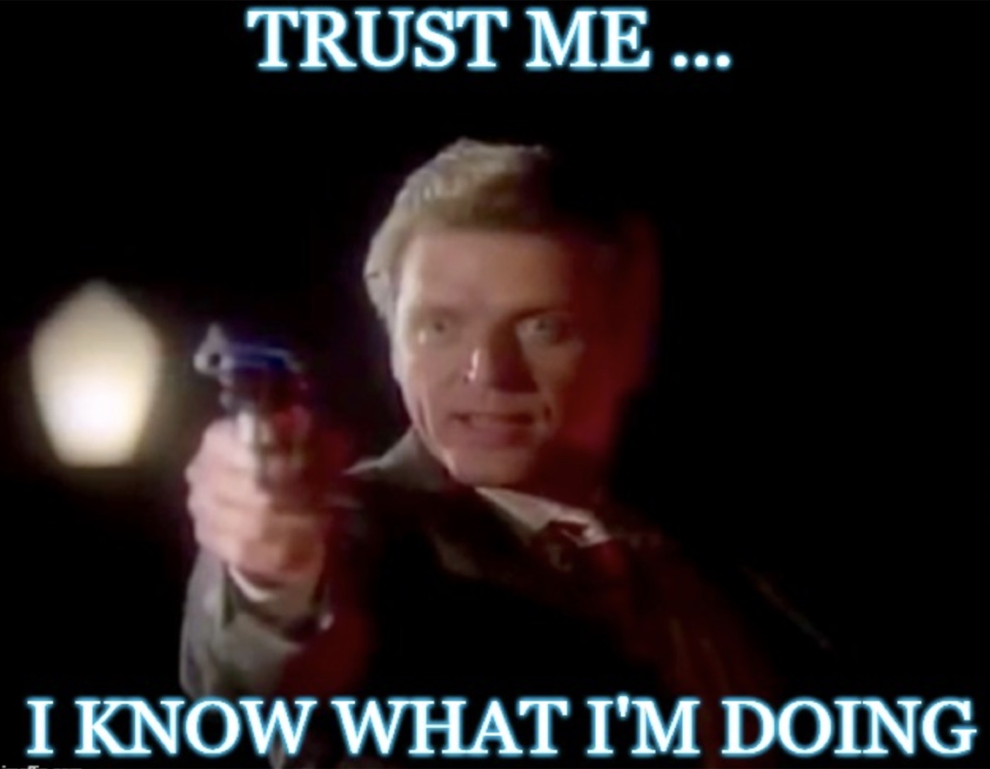 A man pointing a gun at the camera, captioned Trust me, I know what I am doing.